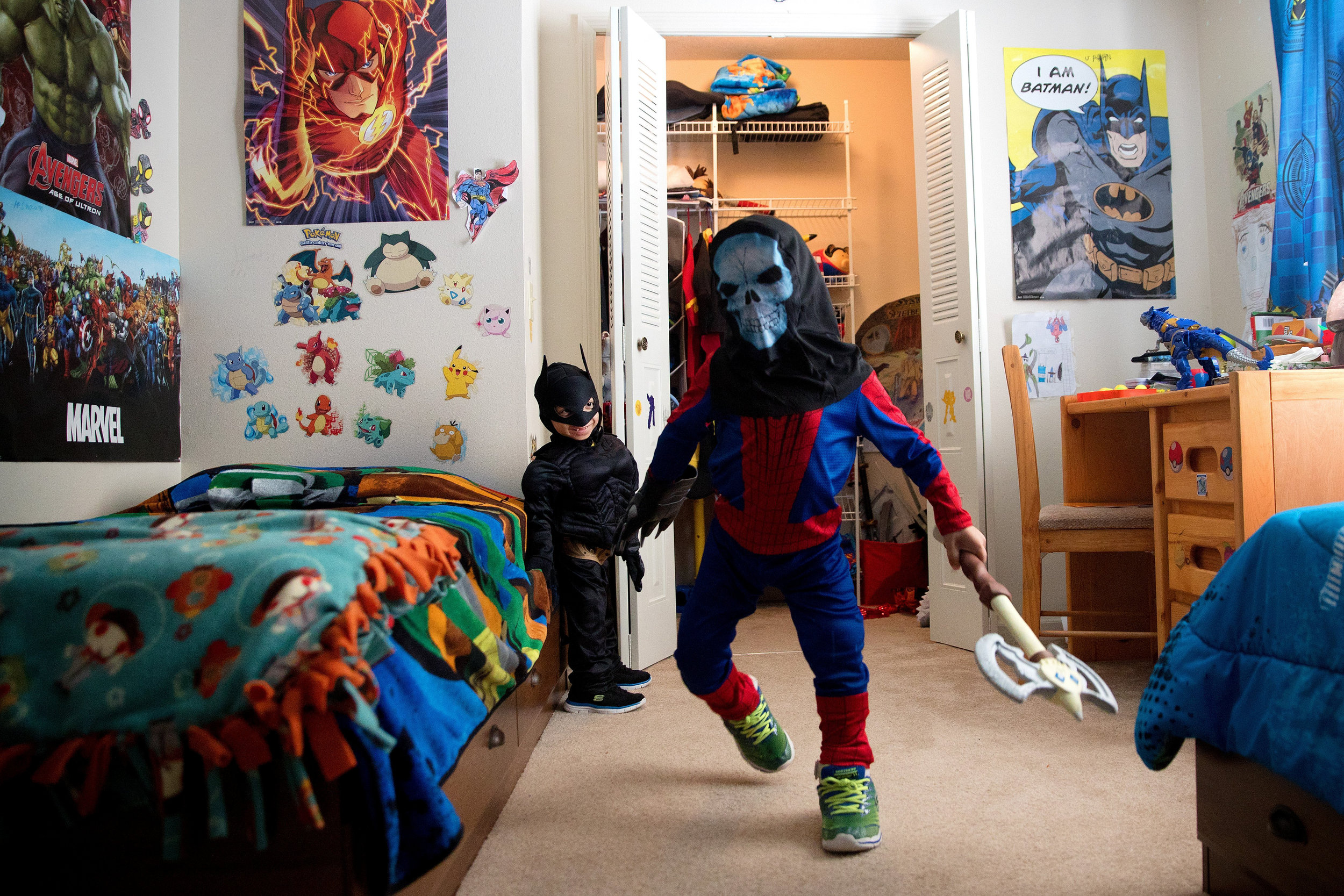 Jahan, left, and Arshaan play at home in their superhero costumes in January.