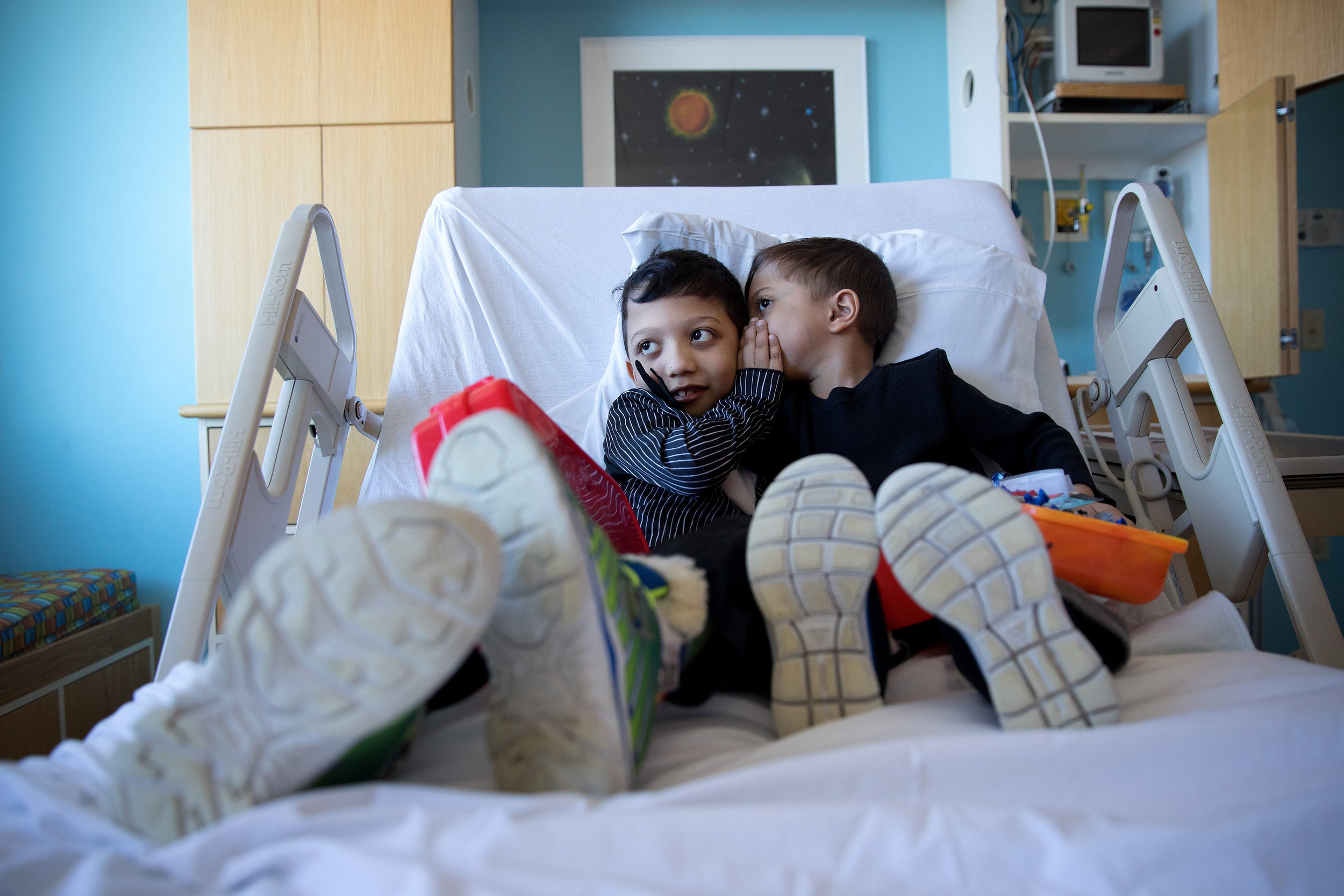 At Children's Hospital & Medical Center, Arshaan, left, and Jahan tell each other secrets before undergoing infusions to regulate high blood calcium levels.